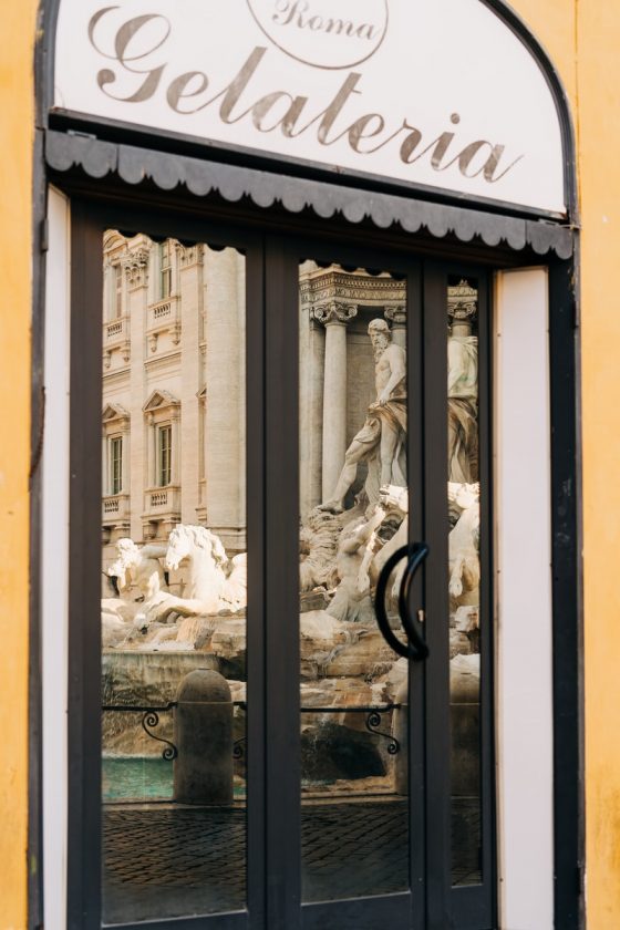 The Trevi Fountain reflected in the window of a gelateria in Rome, Italy