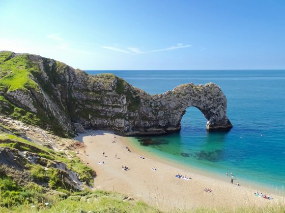 The UK has some gorgeous beaches for example on The Jurassic Coast at Durdle Door Dorset, UK. Photo by Belinda Fewings, Unsplash