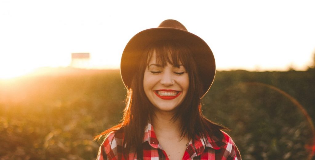 golden hour photography of woman in red and white checkered dress shirt