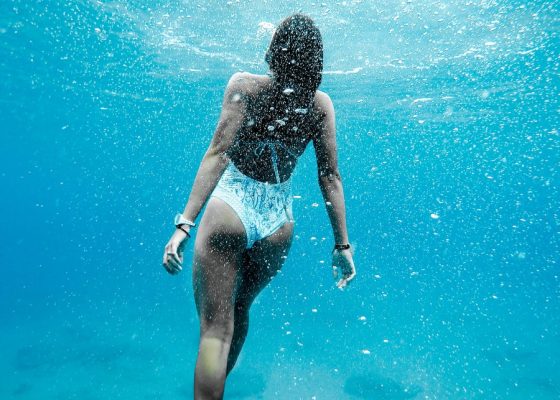 woman swimming under water