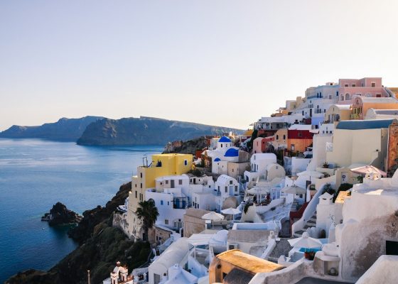 white and brown concrete houses near body of water during daytime